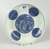 CHINESE PORCELAIN BLUE & WHITE SHALLOW DISH depicting three clawed dragon within clouds,
