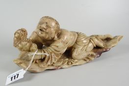 CARVED SOAPSTONE STUDY OF A MAN GRIPPING ONTO A SMALL MYTHICAL-TYPE BEAST on naturalistic leaf base,