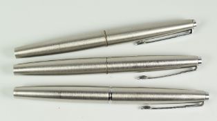 THREE VINTAGE STAINLESS STEEL PARKER FLIGHTER FOUNTAIN PENS with chrome trim