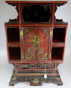 JAPANESE LACQUERED TABLE TOP CABINET having blind panelled central cupboard flanked by open