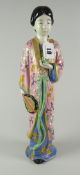 JAPANESE PORCELAIN FIGURINE OF A STANDING FEMALE holding bird & fan in flowing robes, unglazed &