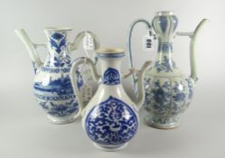 THREE ORIENTAL PORCELAIN BLUE & WHITE EWERS OR WINE JUGS all similarly decorated with foliate floral