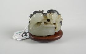 BELIEVED CHINESE JADE DUCK GROUP depicting two carved mirror studies of ducks on hardwood base, 4.