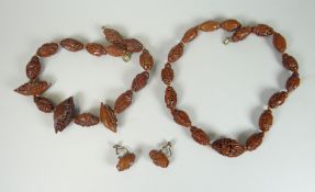 ORIENTAL SUITE OF CARVED NUT JEWELLERY carved as figures and junk boats comprising two necklaces (45