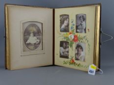 A Victorian photograph album with metal clasp, part filled, dated Christmas 1882