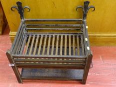 A wrought iron vintage-style dog grate with cinder tray
