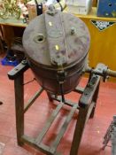 An antique butter churn on stand with G Llewellin & Son label