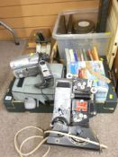 A vintage Pathescope projector with a quantity of film reels, later video cameras, photographic