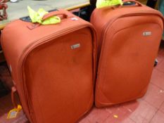 A matching pair of modern canvas wheeled suitcases
