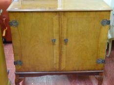 Walnut two door entertainment cabinet on cabriole supports