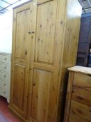 A modern pine two-door wardrobe