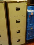 A modern metal four-drawer file cabinet with keys