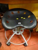 A low level wheeled stool with tractor-type seat