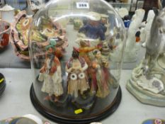 A group of five painted Indian figurines of composition material in traditional style clothing