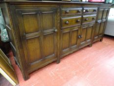 A Priory oak style long sideboard