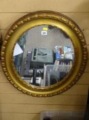 A gilt framed oval wall mirror