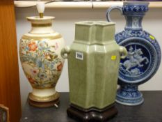 A crackle glazed Celadon vase with elephant handles, German pedestal moon jug and decorative table