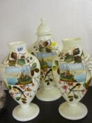 A Victorian milk glass garniture of three vases, hand painted, one with cover