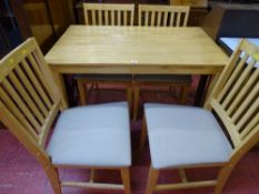 A modern lightwood effect dining table & four chairs