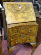 A vintage fall front walnut ladies bureau with concave lower drawers