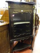 An ebonized Edwardian single-glazed door corner cabinet