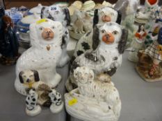 A pair of early Staffordshire pottery cat figurines (some damage) & a collection of comforter dogs