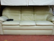 A modern cream leather effect three-seater settee