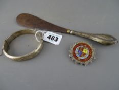 Hollow silver bangle, silver handled shoe horn and a mounted coin