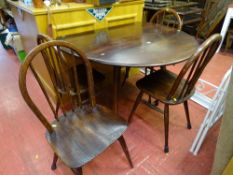 Dark wood Ercol? drop leaf circular table and four chairs