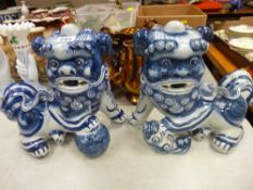 Pair of interesting porcelain temple dogs, approx 10 ins high