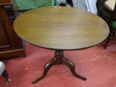 Circular tilt top table with tripod base