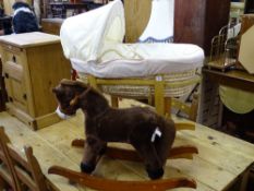 Baby's Moses basket and stand and a small rocking horse