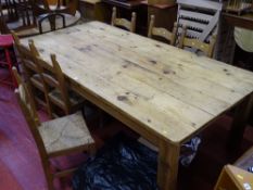 Substantial wooden rustic style dining table (approx 250 x 125 cms) and six rush seated chairs by