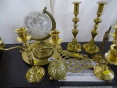 A good pair of brass candlesticks, candelabra, ornamental globe and similar items