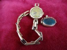 Lady's nine carat gold wristwatch and an agate fob