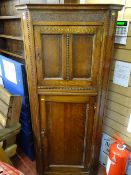 Two door floorstanding corner unit with carved and panel detail