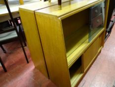Pair of light wood bookcase cupboards with upper sliding glazed doors and wooden sliding doors