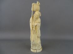 Ivory figure of an Oriental gent with basket on head