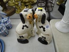 A pair of black and white Staffordshire dogs