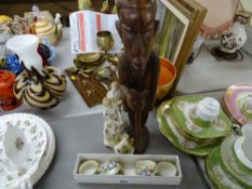 A carved African figure, continental figurines, china napkin rings etc