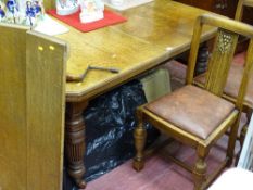 Oak wind-out extending dining table with two leaves and wind-out handle and four rexine padded