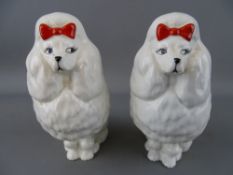 Pair of Beswick poodles with red bows