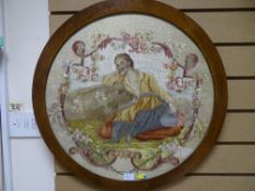 Circular framed silkwork embroidered picture of a young girl with painted face detail