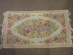 Kashmiri Chain hand stitch rug, tassel ended cream ground with central floral cameo, 120 x 69 cms