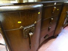 Oak sideboard with three central drawers and two flanking cupboards