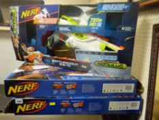 Three boxed Nerf toy blasters
