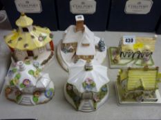 Four unboxed Coalport china cottages and two others