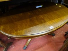 Oval mahogany coffee table on claw feet