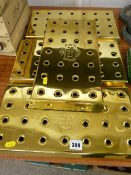 Four brass Stella Artois bar drainers