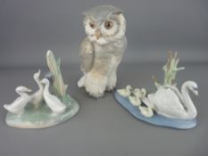 Nao porcelain model of an owl and one of three ducks and a Lladro model of a swan with cygnets